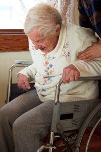 graphicstock caregiver helping senior lady get up from wheelchair rtP0JWSQO  e1572562152714